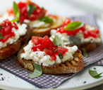 Tomato crostini topped with cottage cheese