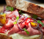 Rare roast beef sandwich, with red onions and basil 