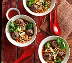 Thai-style meatballs in a noodle and vegetable broth