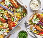 Greek-Style Sausage And Butter Bean Traybake | Traybake Recipes | Tesco Real Food