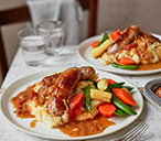 Sausage and cheesy mash with tomato gravy | Tesco Real Food