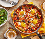 Baked eggs and Manchego with rocket and almond salad​ | Tesco Real Food