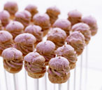 Mini hazelnut choux buns coated in pink icing sugar | Tesco Real Food