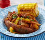 Jerk chicken stew with campfire corn on the cob | Tesco Real Food