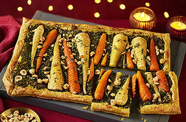 Hasselback honey parsnip and carrot puff pastry tart with winter pesto