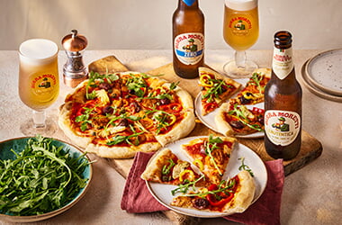 Vegan pizza with artichoke, olives and peppers