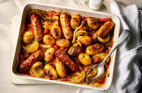 Claire Sisk’s gloriously sticky take on traditional honey and mustard sausages with added roasted veg, all in one easy-to-throw-together traybake. A self-taught blind cook, Claire creates simple, delicious dishes inspired by family favourites and her travels. She became the first blind cook to regularly demonstrate live on UK daytime television.