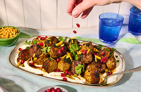 This sweet and tangy baby potato chaat is the ultimate side dish. Spiced potatoes are placed on a bed of Greek yogurt and topped with homemade green chutney and tamarind sauce. Garnish with Bombay mix for crunch and pomegranate seeds for a fruity hit!