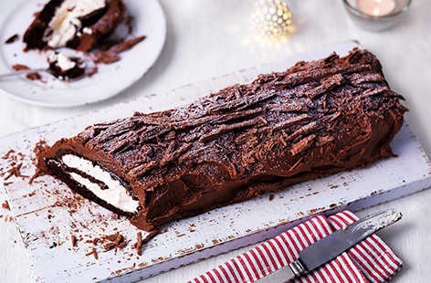 Slice into this beautiful Christmas dessert to discover the spongey, cream centre that's hidden beneath lashings of rich chocolate icing. The flaky chocolate bark topping makes this traditional yule log even more deliciously special