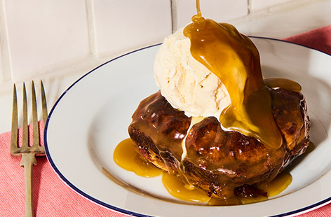 Classic sticky toffee pud has been given a seasonal Easter twist with hot cross buns! It’s served with a delicious homemade toffee sauce and we like it with a scoop of ice cream but cream or custard would be yummy too.