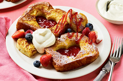 French toast gets the Valentine's Day treatment with a heart-shaped jam middle. This charming breakfast or brunch recipe is simple enough for all ages to help make, but looks so pretty and impressive! Use another flavour of jam, if you prefer.