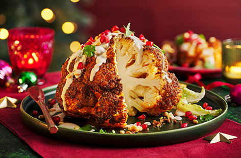 This impressive roasted cauliflower makes a delicious vegan main for Christmas or Boxing Day. Topped with tahini and pine nuts for Middle Eastern-inspired flavours and finished with a sprinkling of pomegranate seeds, serve this gorgeous dish alongside all the festive trimmings.