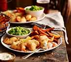 Beer-battered scampi with sweet potato chips and mushy peas | Tesco Real Food